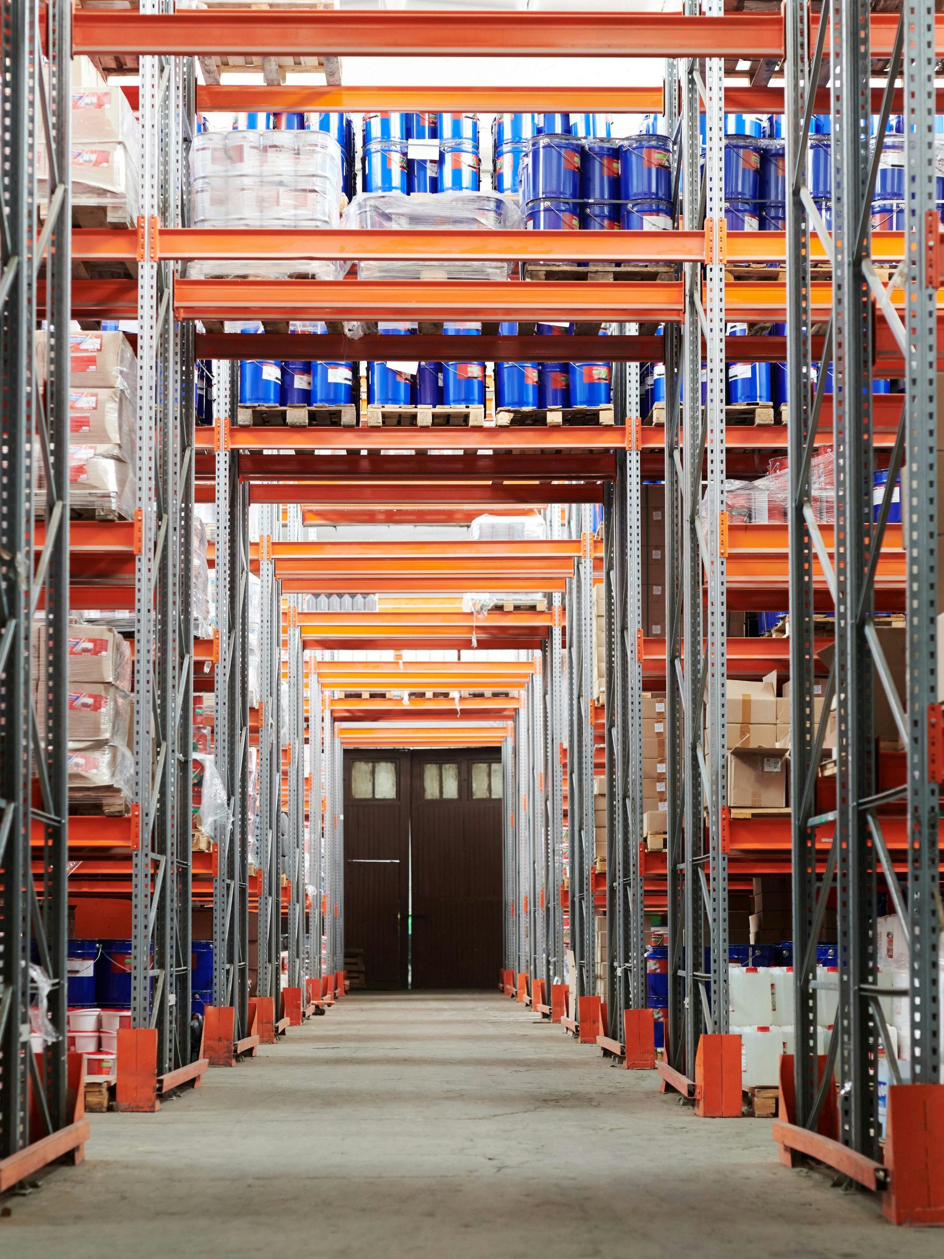 Wide angle view of a warehouse with stocked shelves and boxes.